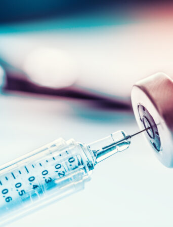 Close-up medical syringe with a vaccine.