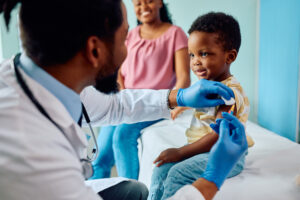 pediatrician giving vaccine to child at doctor's office